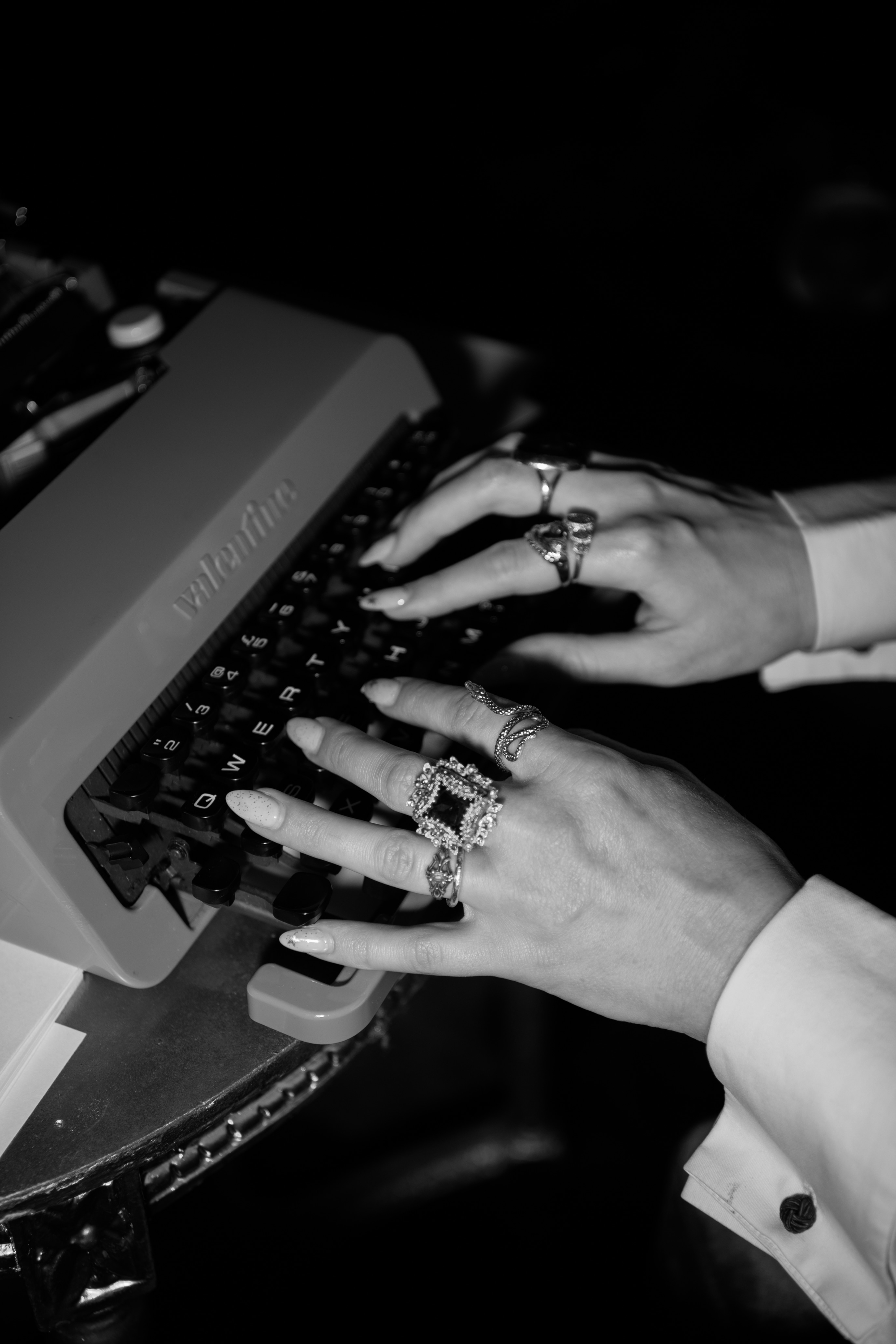 Typewriter hands with statement rings
